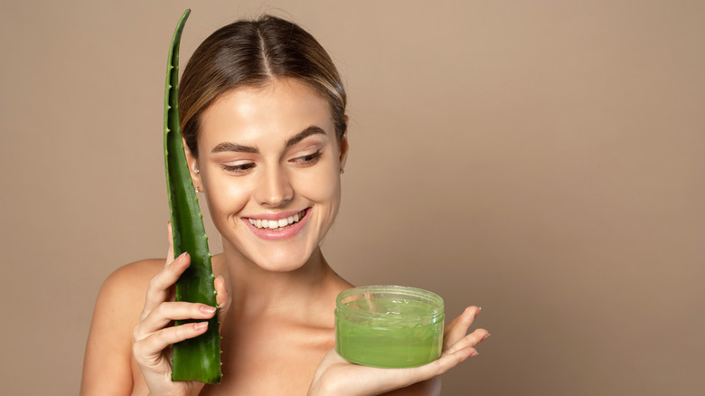 woman holding aloe vera