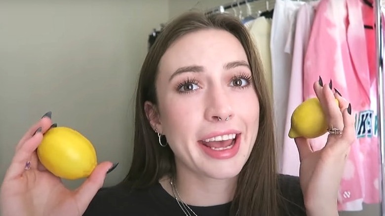woman holding up lemons