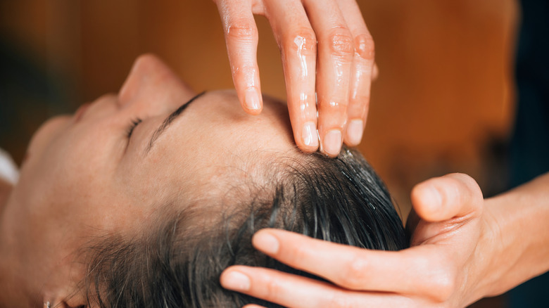 woman getting hair oiled