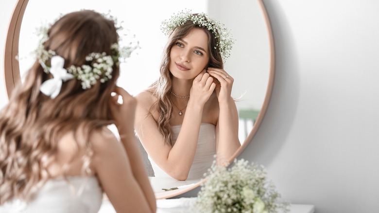 Bride putting on accessories