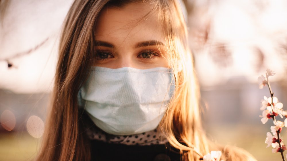 Woman wearing a mask outdoors