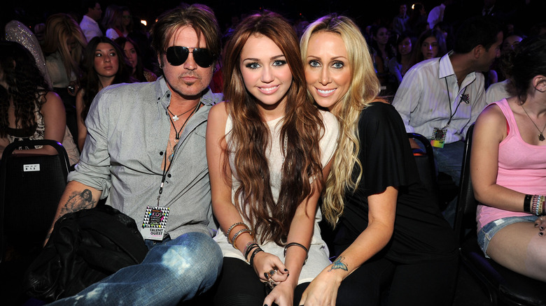 Billy Ray, Miley, and Tish Cyrus at an award show