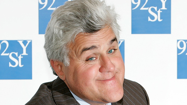 Jay Leno smiles while signing books