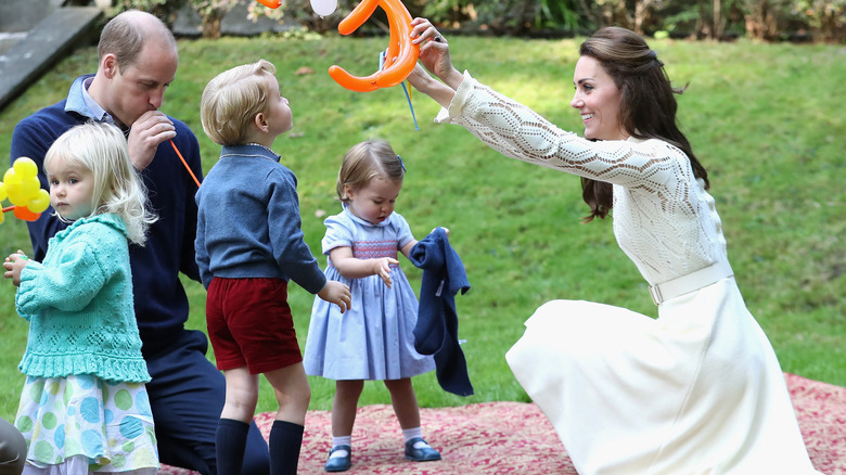 Royal children playing with parents and other children