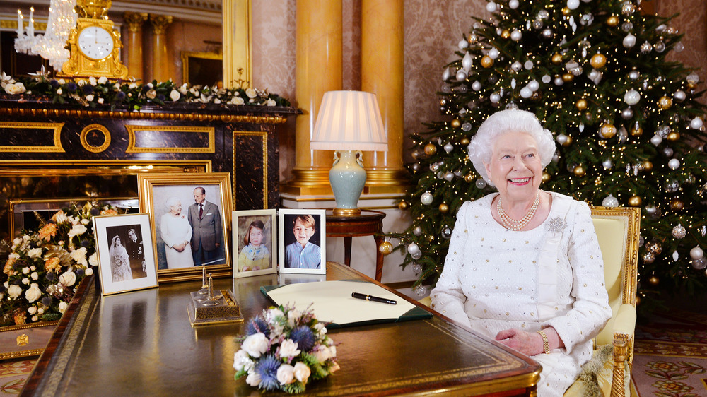 Queen Elizabeth laughing by tree