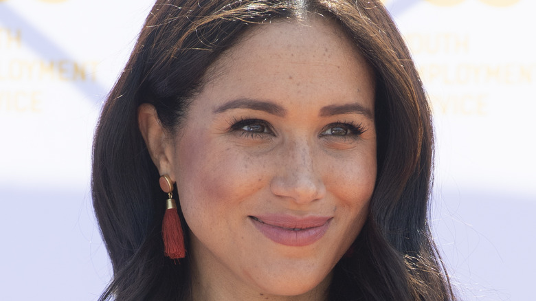 Meghan Markle smiles at an event