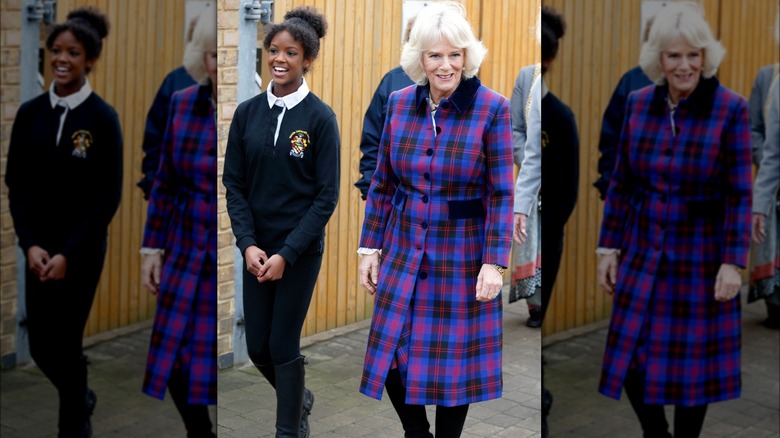 Queen Camilla walking alongside a girl 