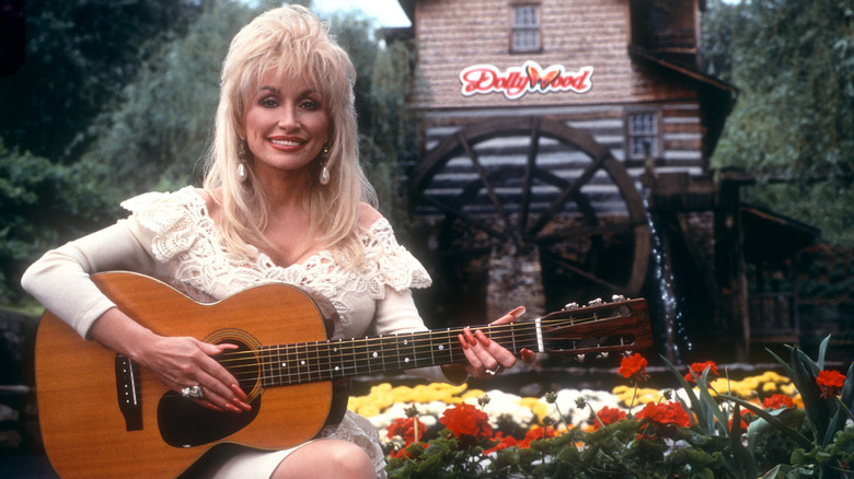 Dolly Parton playing acoustic guitar in Dollywood