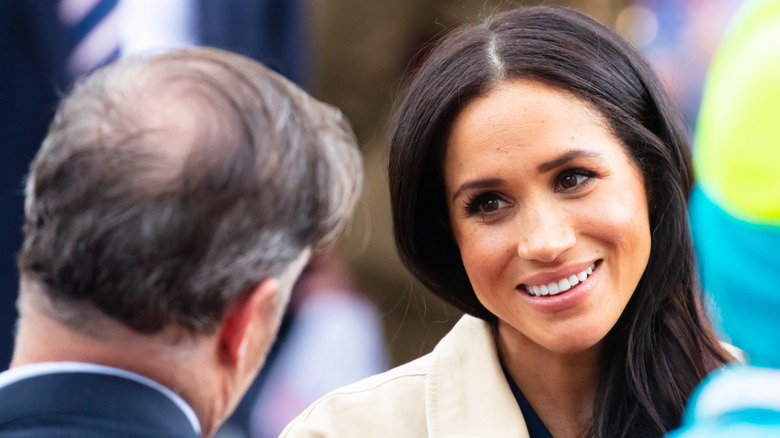 Meghan Markle talking to man during walkabout