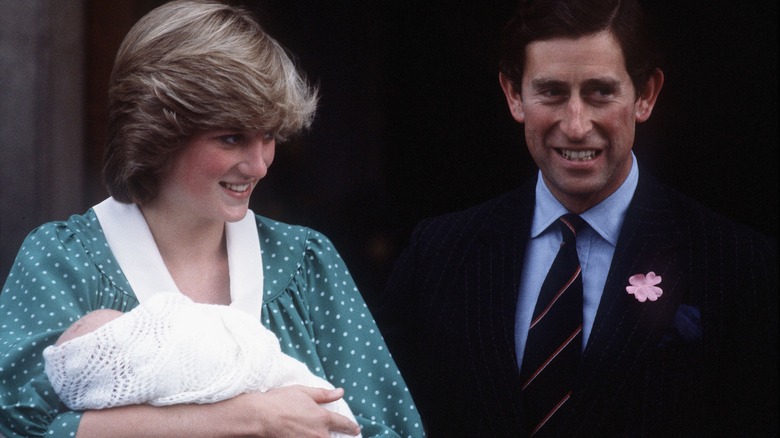 Princess Diana holding baby Prince William with Prince Charles