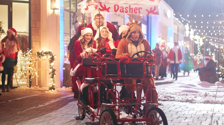 The cast of The Santa Summit riding in a bike cab