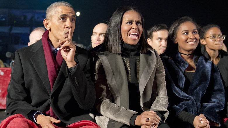 Barack, Michelle, and Sasha Obama sitting together