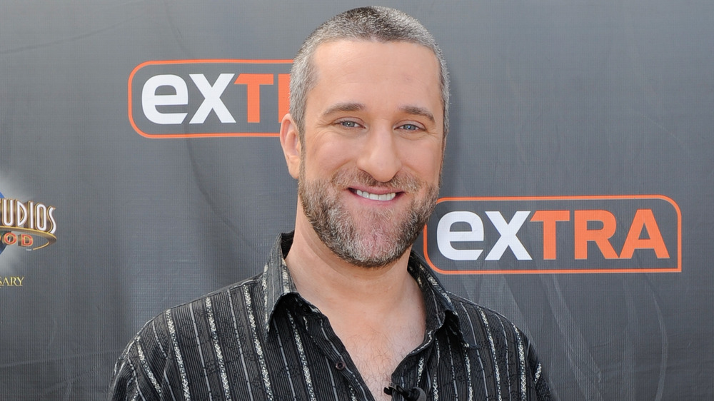 Dustin Diamond smiling at an event for Extra 