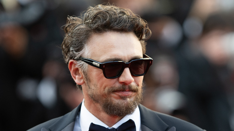 James Franco smiling in sunglasses and a tuxedo