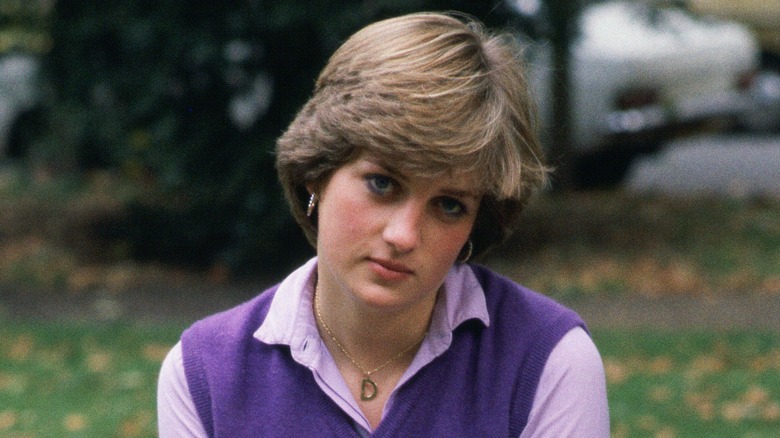 Princess Diana wearing purple and looking completely disinterested