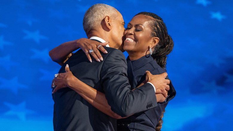 Barack Obama and Michelle Obama hugging and smiling