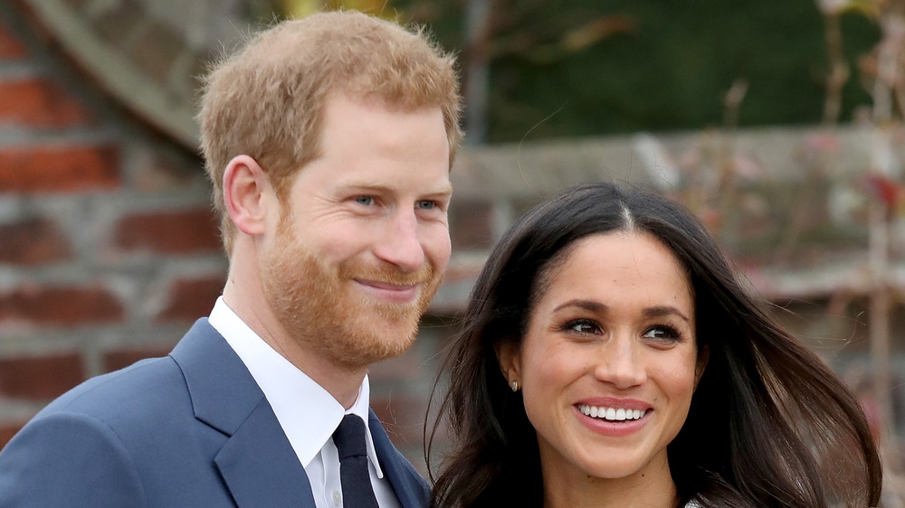 Meghan and Harry smile for photographers