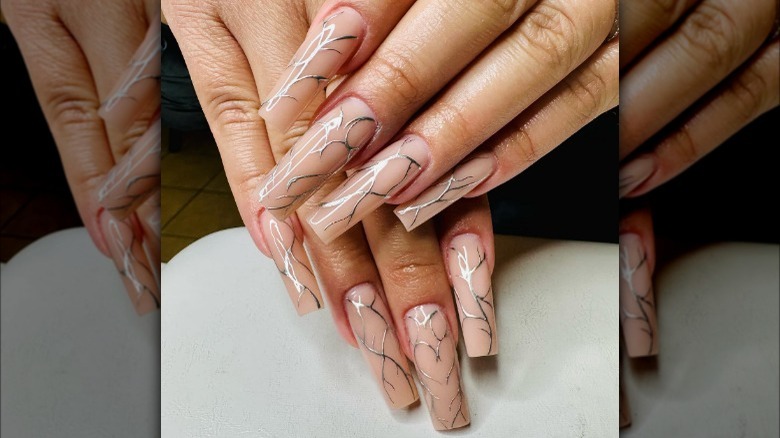 Light pink sculpted nails with silver decoration