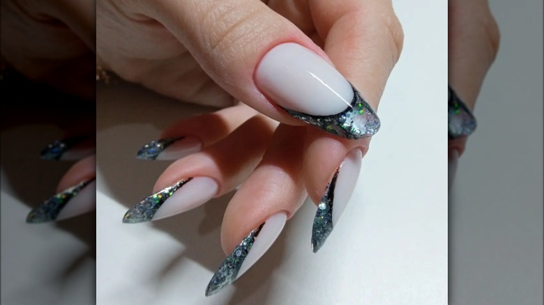 Cream sculpted nail with silver and green sparkly tip