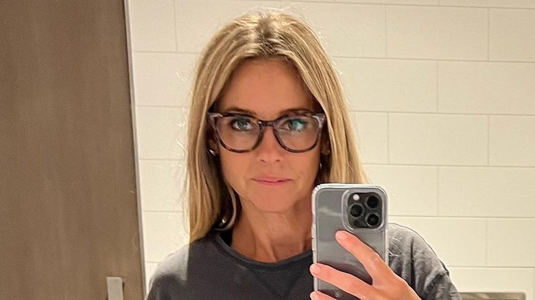 Nicole Curtis taking a selfie in an airplane bathroom