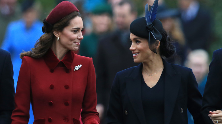 Princess Catherine looking at Meghan Markle with amusement