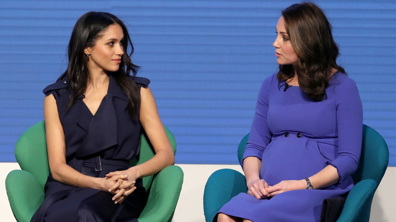 Princess Catherine having a conversation with Meghan Markle