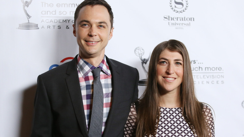 Mayim Bialik and Jim Parsons smiling at the cameras