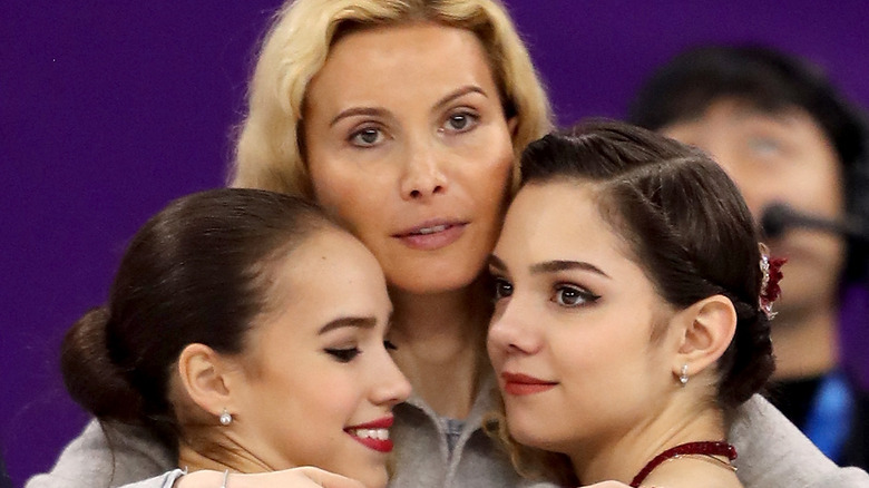 Eteri Tutberidze hugs figure skaters