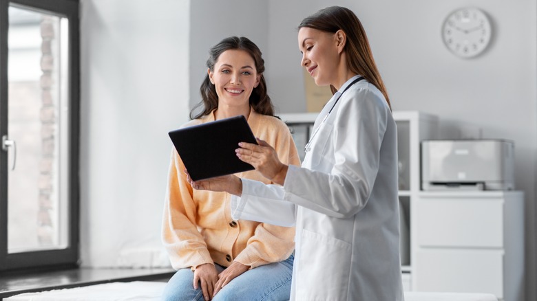 Woman talking to doctor