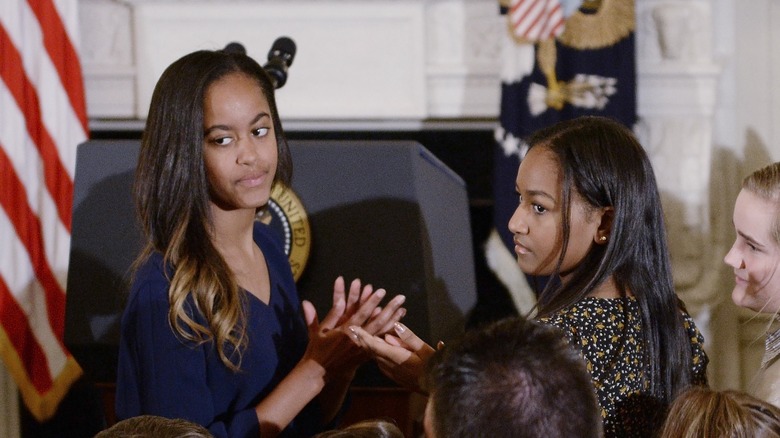 Malia and Sasha Obama side by side with serious expressions