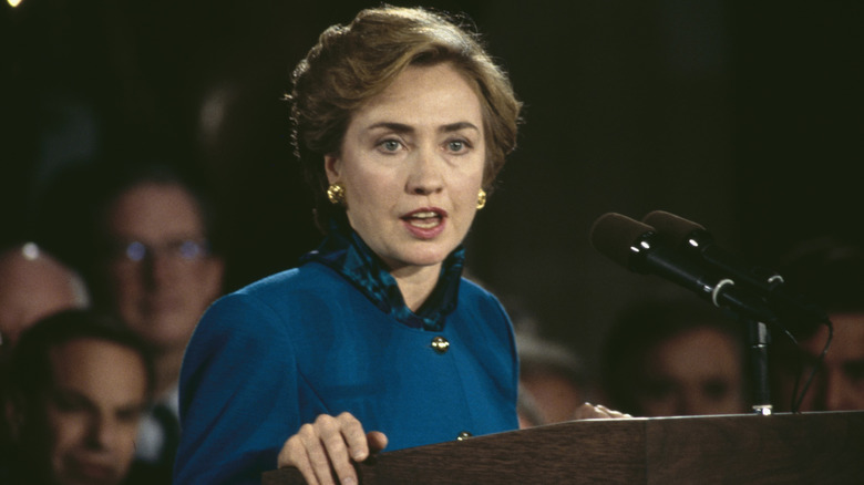 Hillary Clinton speaking onstage in 1993 in a blue suit