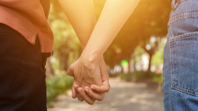 Couple holding hands taking a walk