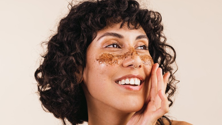 Woman exfoliating her skin