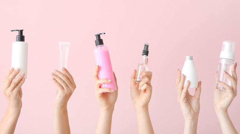 Hands each different bottles of a skincare product