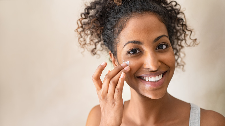 Woman applying face cream