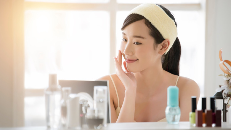 Young woman applying skincare products