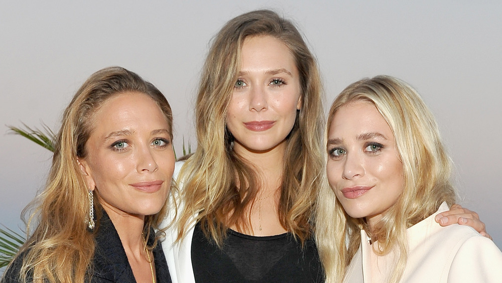 Elizabeth Olsen poses with sisters Mary-Kate and Ashley