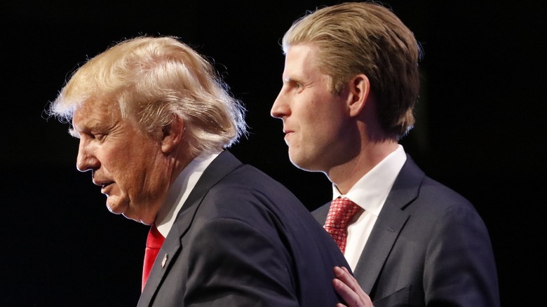 Eric Trump standing next to Donald Trump