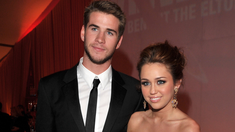 Young Liam Hemsworth and Miley Cyrus posing