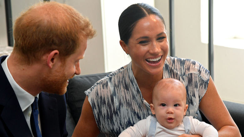 Prince Harry, Meghan Markle, and Archie posing for photo