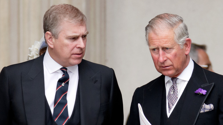 Prince Andrew talking to King Charles III