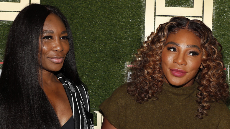 Venus and Serena Williams pose on the red carpet