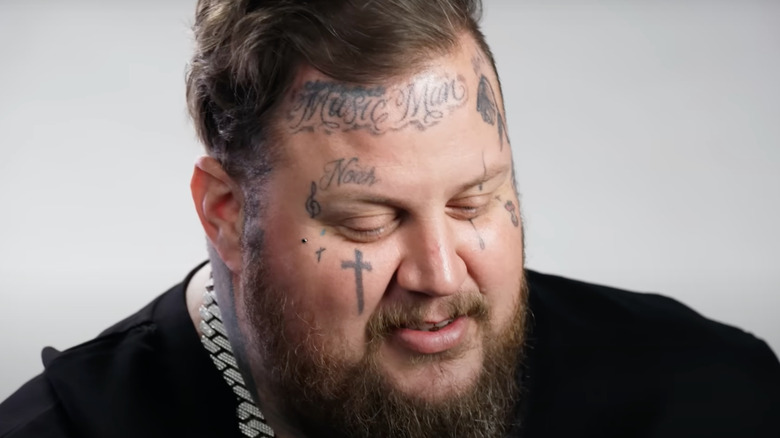 Closeup on Jelly Roll's face tattoos, including the tattoo of his son's name