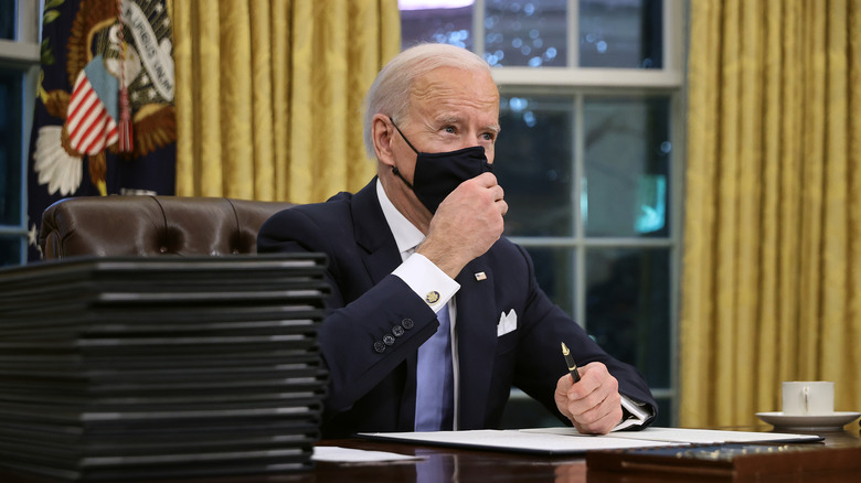 Joe Biden sitting at the resolute desk 