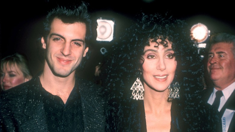 Rob Camilletti and Cher smiling side-by-side in the 1980s