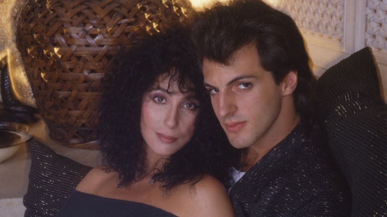 Cher leaning on Rob Camilletti in 1980s