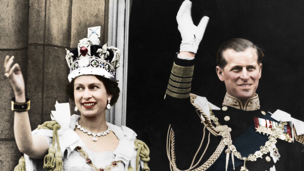 Queen Elizabeth and Prince Philip waving