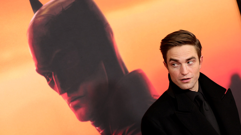 Robert Pattinson with Batman poster