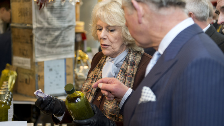 King Charles III and Camilla, Queen Consort inspecting olive oil 