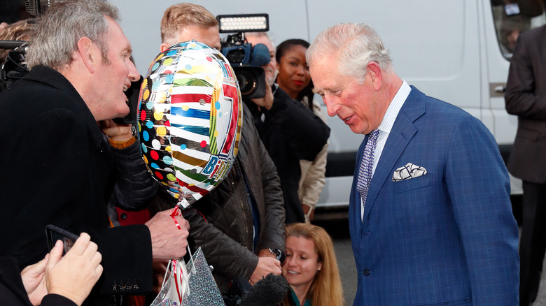 King Charles III talking to reporters 